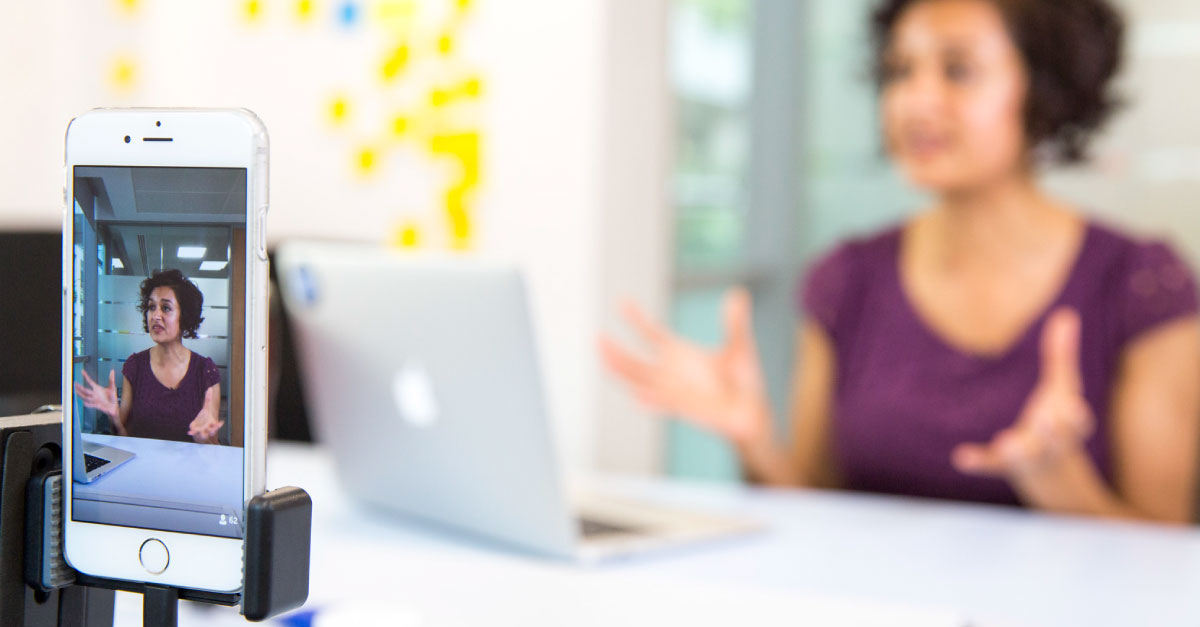 Photo of a woman undergoing user testing and being recorded on a mobile phone