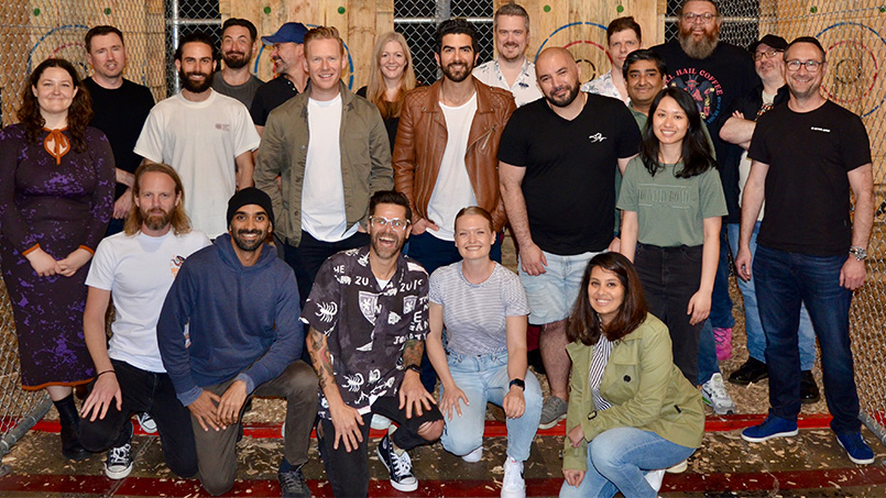 Photo of some of the Sitback team members lined up in three rows and smiling at the camera. They really do seem like a charming bunch.