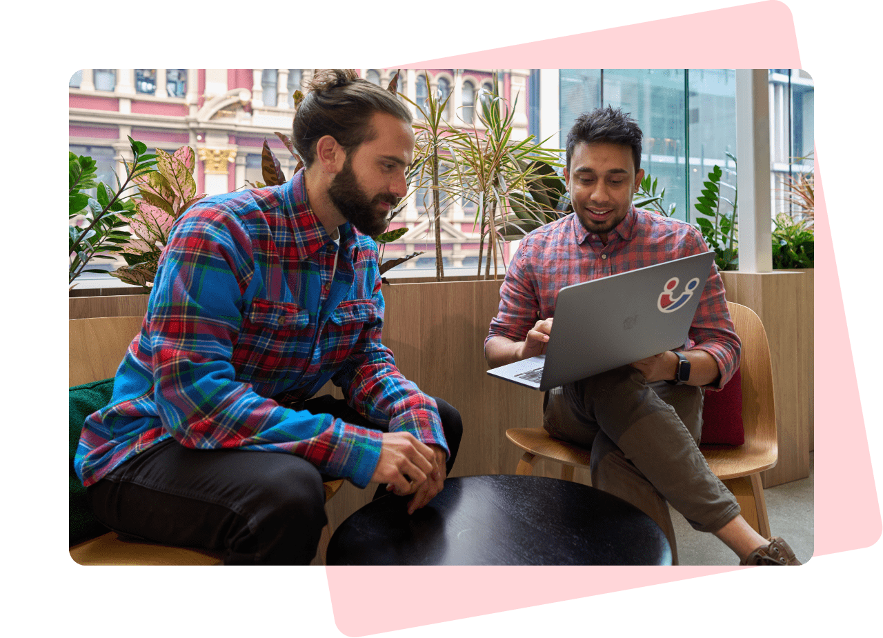 Services - Support & Optimisation. Two men discussing a website on a laptop screen.