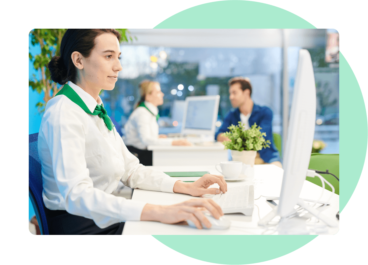 Female bank employee working at a computer.