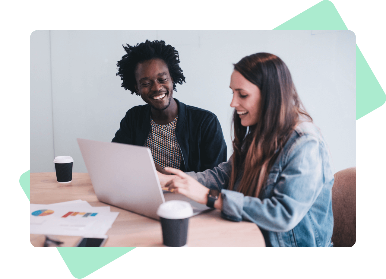 Services - Data and Analytics - A man and a woman laughing in front of a laptop.