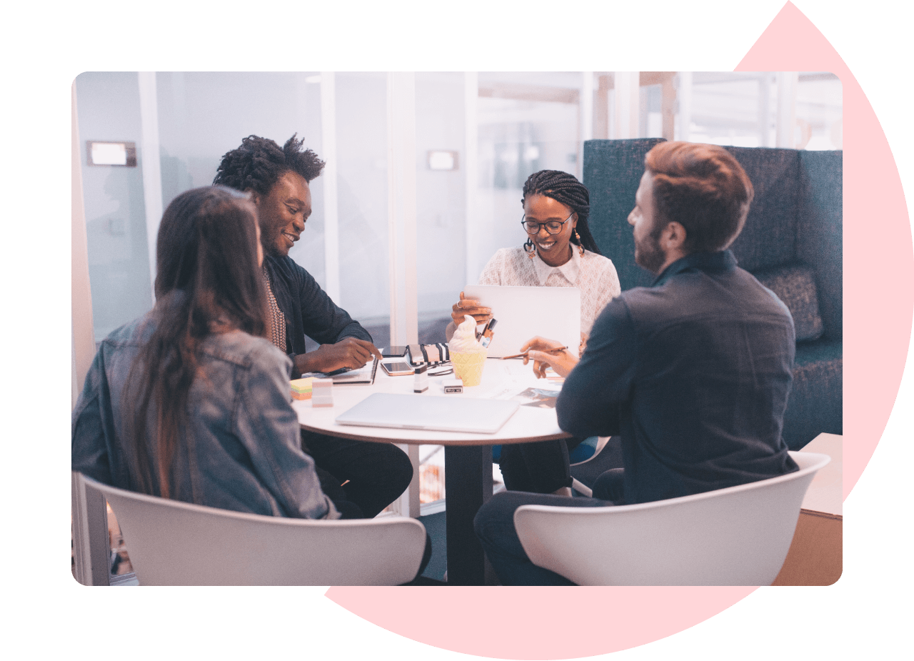 Services - Data and Analytics - 2 men and 2 women sat around an office table looking at business metrics