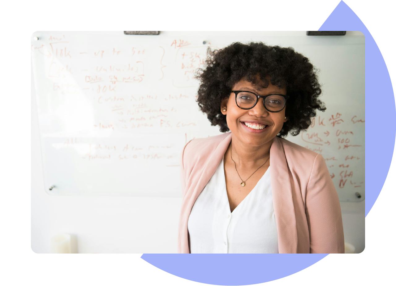 Woman smiling in front of a whiteboard