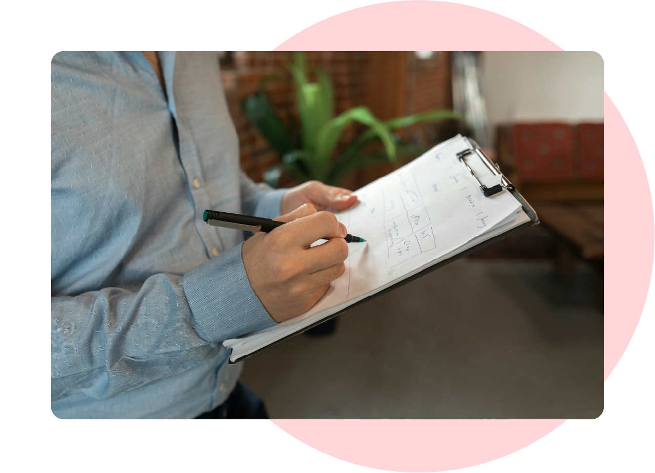 Man holding a checklist on a clipboard and ticking off items